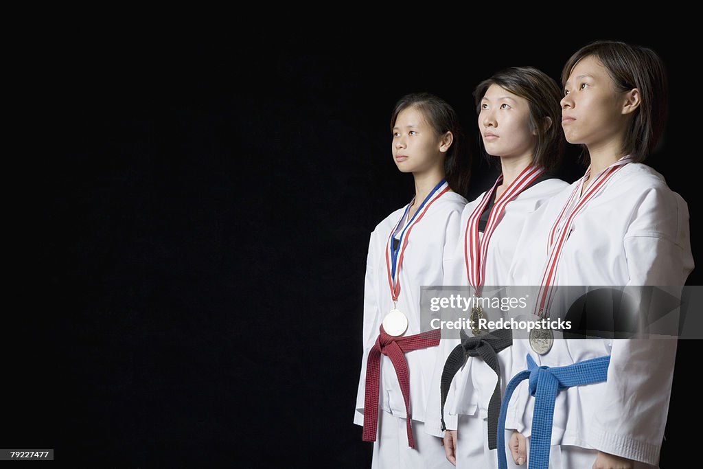 Three young women standing with their medals