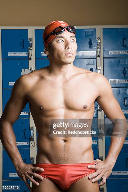 close-up of a young man standing in a locker room - young men in speedos stock pictures, royalty-free photos & images