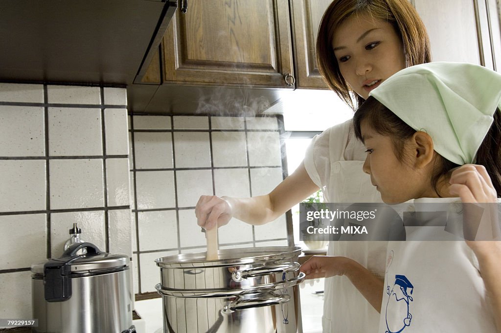 Mother and daughter cooking in kitchen