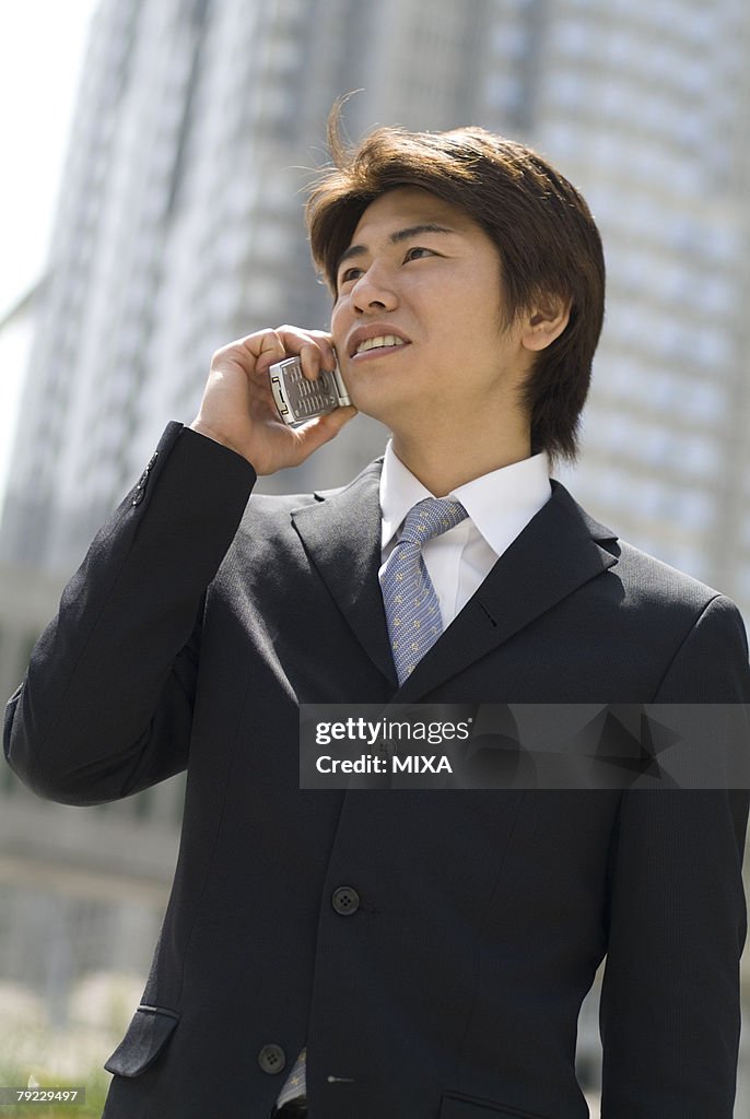 Young businessman talking over mobile phone