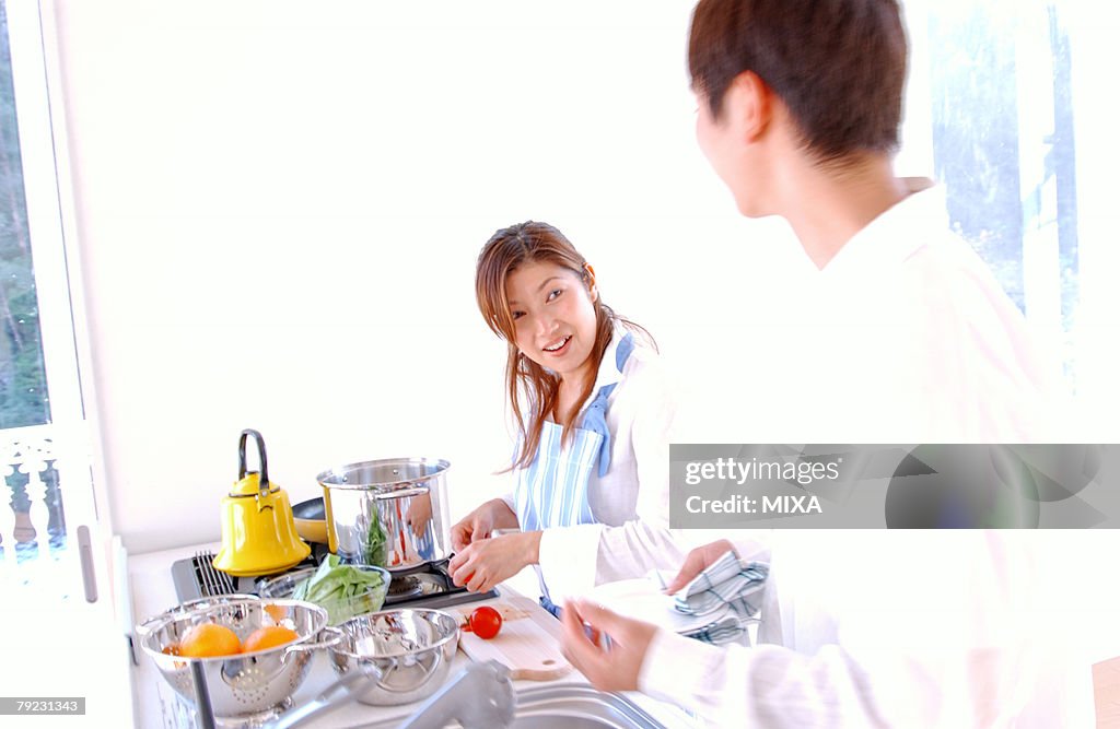 A young couple cooking in a kitchen