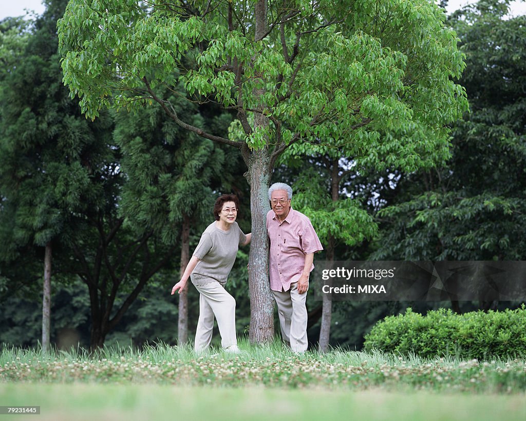 Senior couple standing under tree