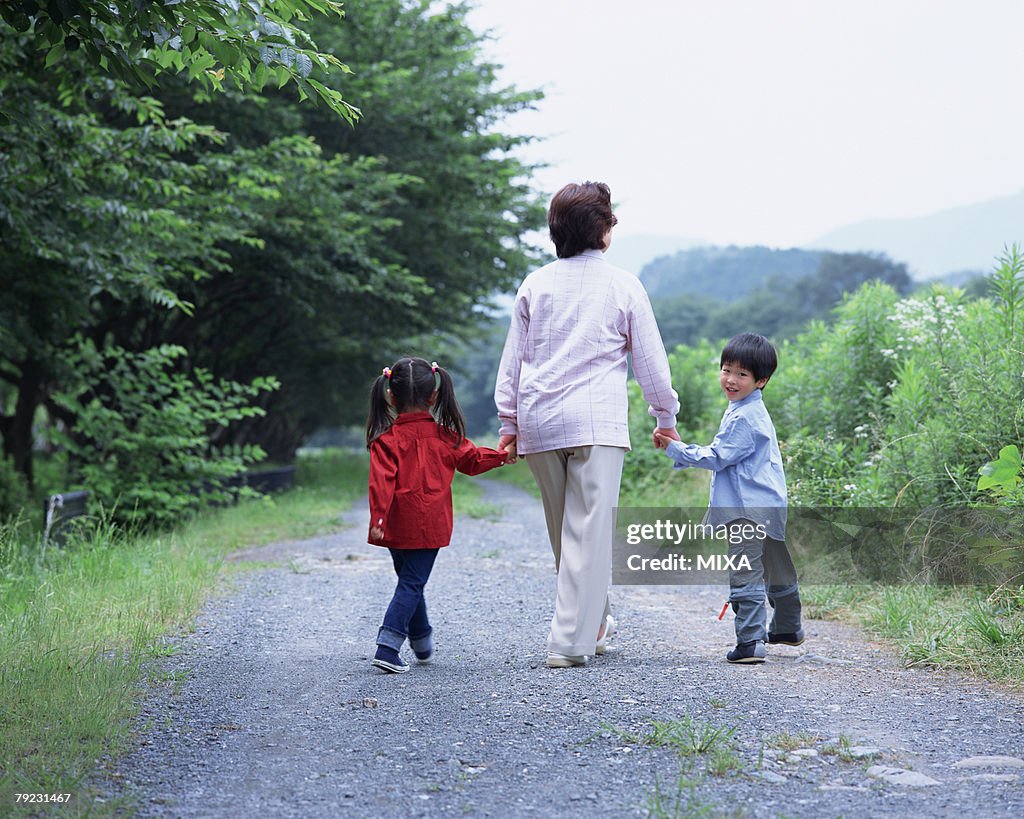 A grand mother walking with grand children