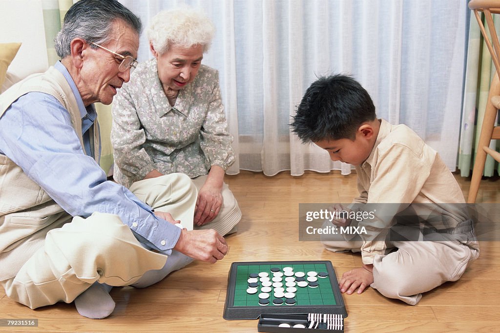 A grand father and a grand child playing with game