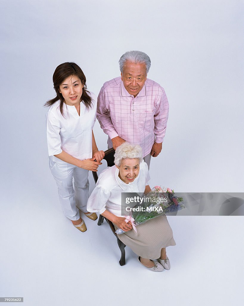 A senior woman holding flower