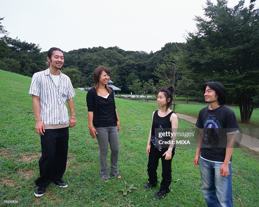 Four young people standing in fields