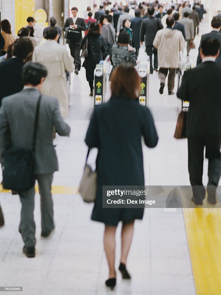 Commuters going though turnstile (blurred motion)