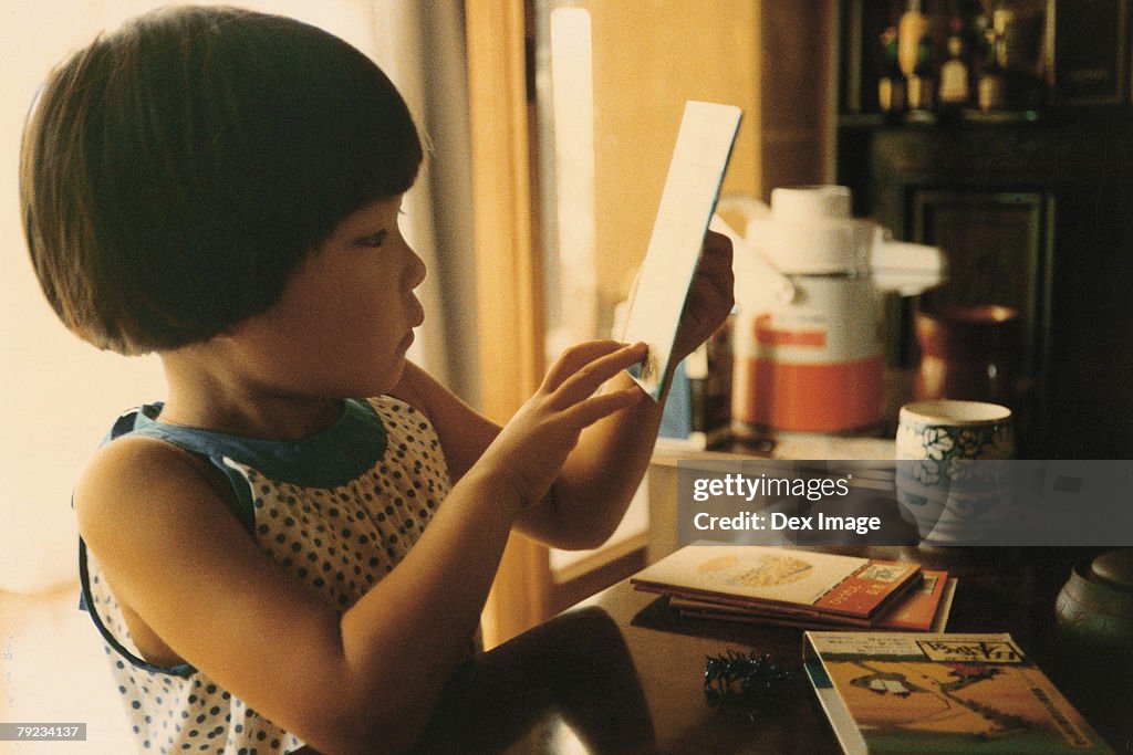 Portrait of a girl reading books