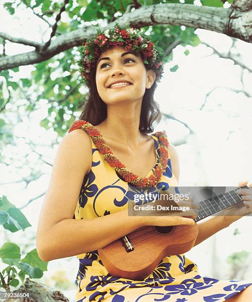 hula dancer playing ukelele - ukulele stock-fotos und bilder