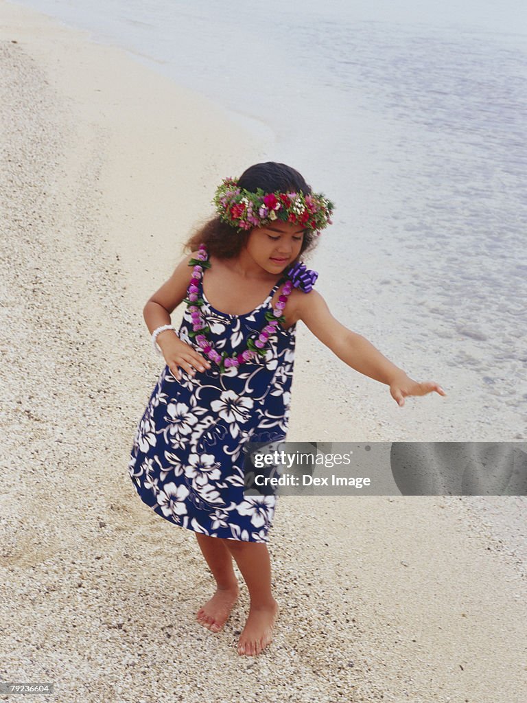 Little hula girl dancing at a beach