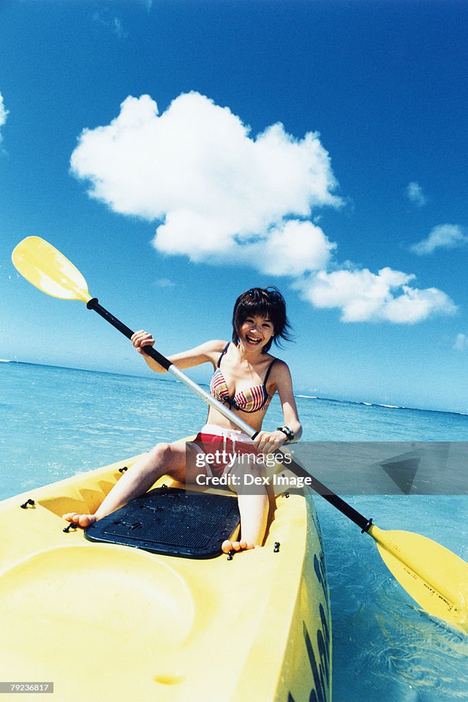 Young woman sea kayaking