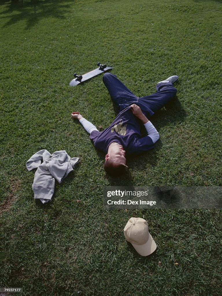 Young man lying on grass