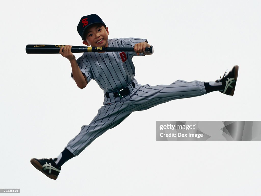 Young Baseball player holding bat in mid-air