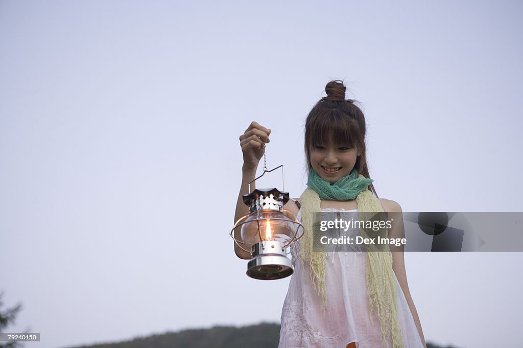 Woman holding a lamp 