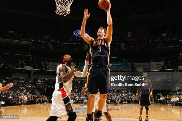 Troy Murphy of the Indiana Pacers goes up with the ball against Gerald Wallace of the Charlotte Bobcats on December 31, 2007 at the Charlotte Bobcats...