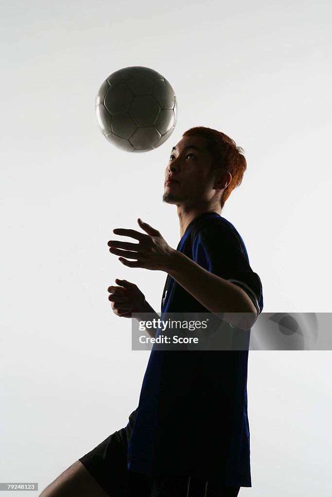 Soccer player juggling ball