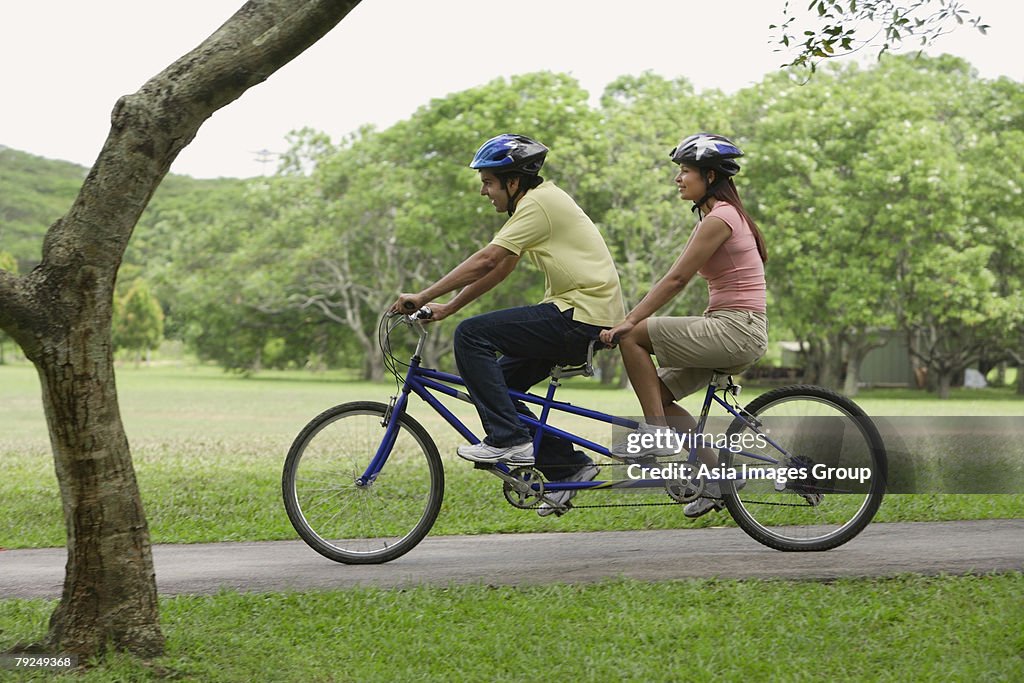 A couple ride a bike together