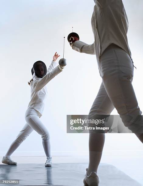 two people fencing - fencing sport stock pictures, royalty-free photos & images
