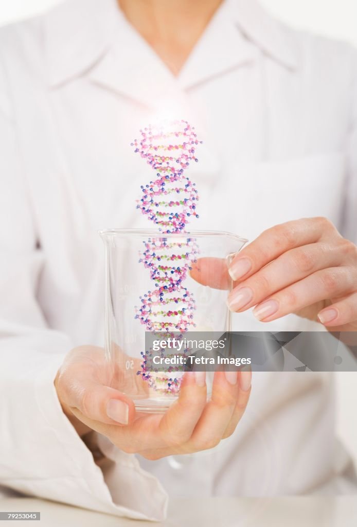 Hands holding DNA in beaker