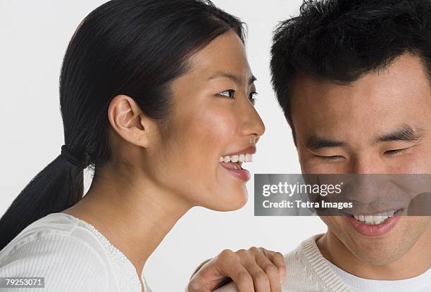 woman telling man a secret - mouth talking stock pictures, royalty-free photos & images