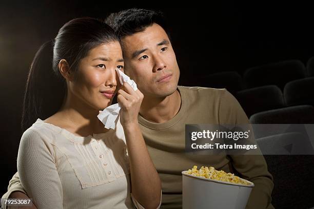 couple watching a sad movie - boyfriend crying stock-fotos und bilder