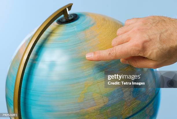 hand spinning globe - spinning globe stock pictures, royalty-free photos & images