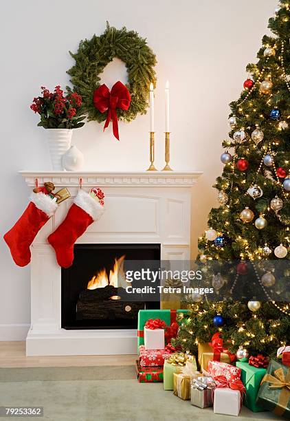 christmas tree with presents and fireplace with stockings - stockings stock pictures, royalty-free photos & images