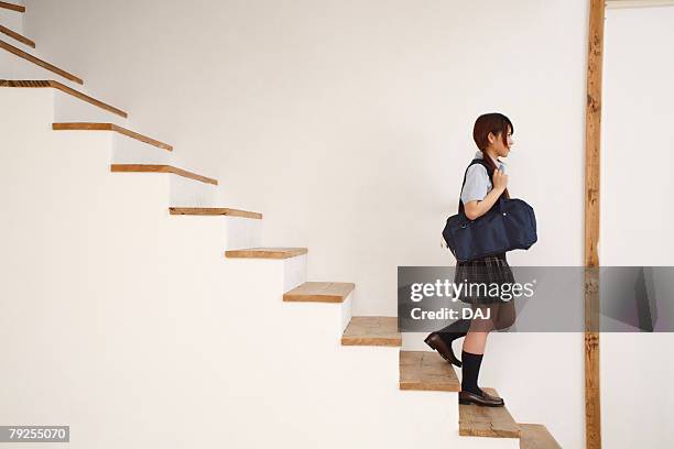 high school student taking down stairs - japanese tree stockfoto's en -beelden