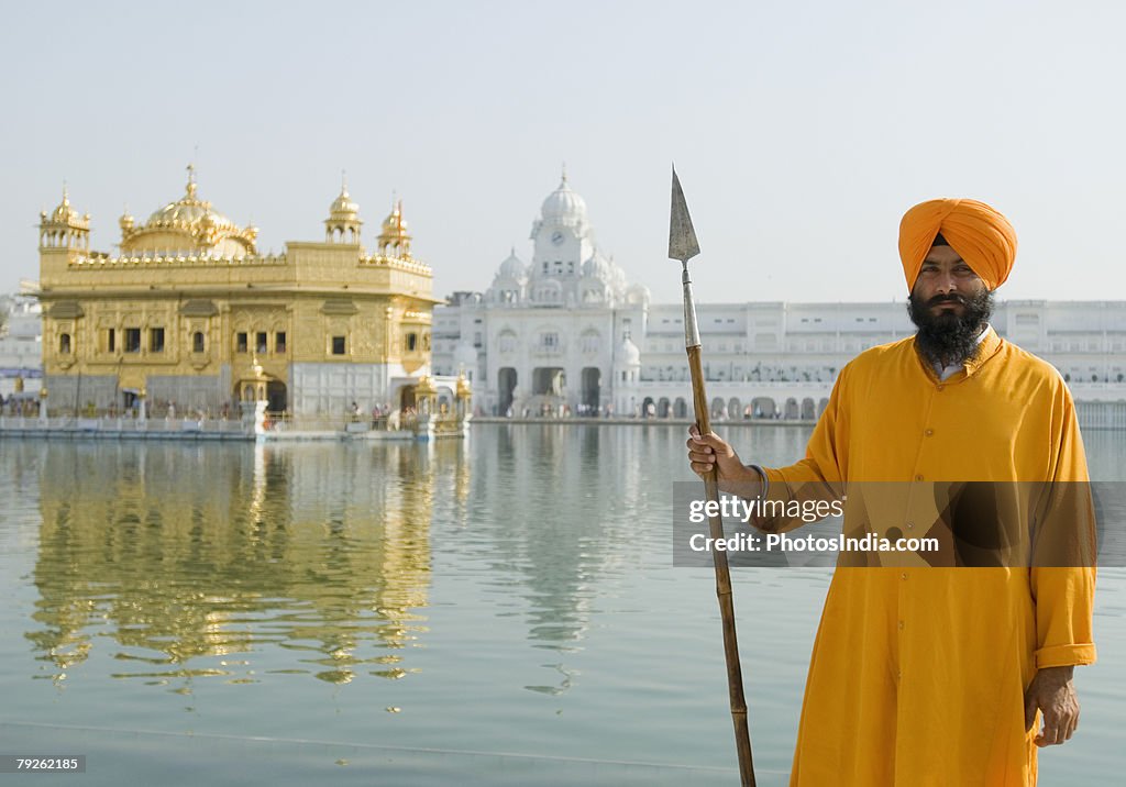 "Portrait of a Sikh guard holding a spear, Golden Temple, Amritsar, Punjab, India"