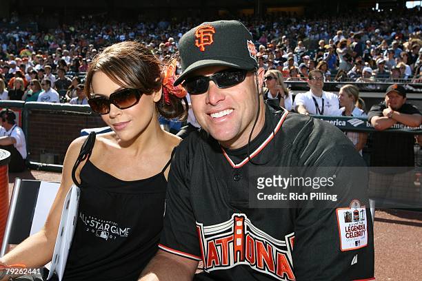 Snow of the National League sits with Alyssa Milano during the Taco Bell All-Star Legends & Celebrity Softball Game at AT&T Park in San Francisco,...