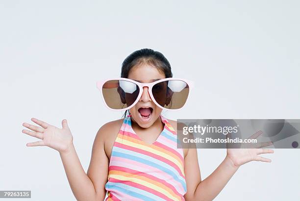 close-up of a girl wearing sunglasses - big sunglasses stock pictures, royalty-free photos & images