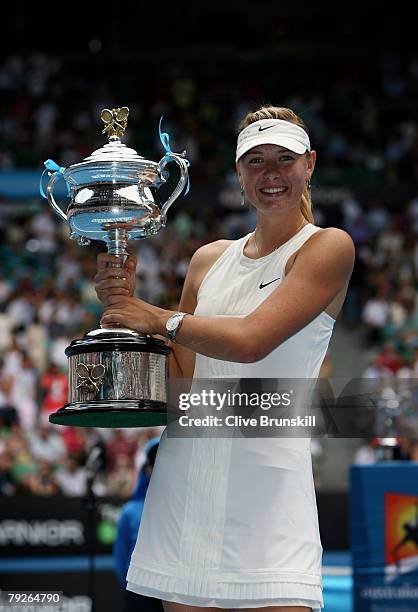 Maria Sharapova of Russia holds aloft the Daphne Akhurst Memorial Cup after winning the women's final match against Ana Ivanovic of Serbia on day...
