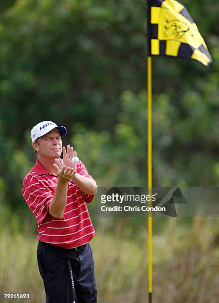 Jeff Sluman catches a ball thrown by his caddie on the 8th green during the first round of the 2008 Turtle Bay Championship held on the Palmer Course...