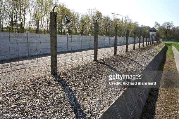Partly-reconstructed guard tower and perimeter fence at the site of the former Dachau Nazi concentration camp in Bavaria, Germany, 2014. The site is...