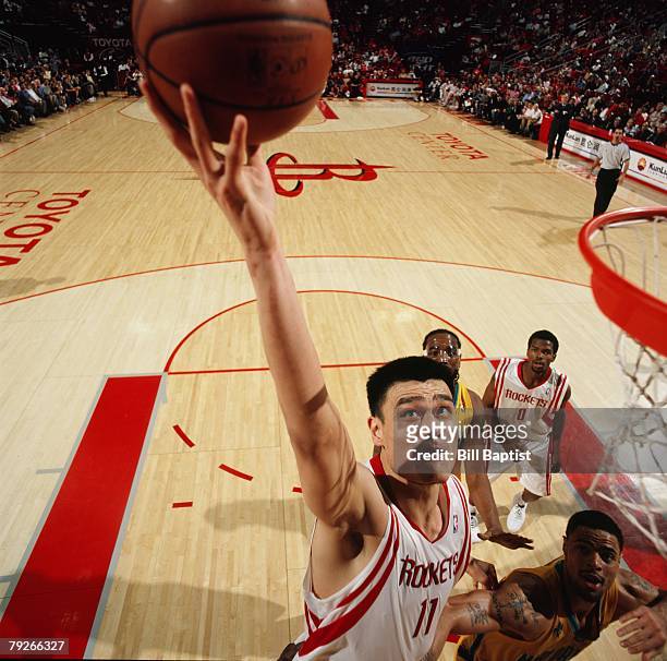 Yao Ming of the Houston Rockets goes to the basket against Tyson Chandler of the New Orleans Hornets during the game on January 13, 2008 at the...