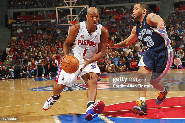Chauncey Billups of the Detroit Pistons moves the ball while Damon Stoudamire of the Memphis Grizzlies runs after him during the NBA game at the...
