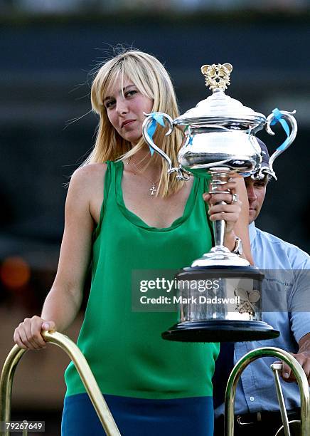 Maria Sharapova of Russia poses with the Daphne Akhurst Memorial Cup on a boat along the Yarra River after her victory in the women's final match...