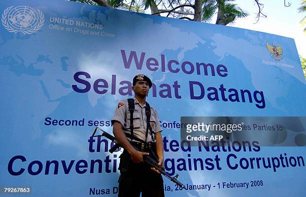 Policeman stands guard in front of a banner on anti-Corruption Summit in Nusa Dua on Bali island, 26 January 2008. The Indonesian government has...