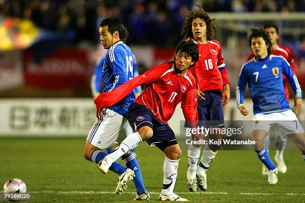 Naohiro Takahara of Japan and Gary Medel of Chile in action during international friendly match between Japan and Chile at the National Stadium on...