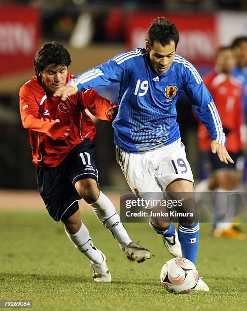 Naohiro Takahara of Japan and Gary Medel of Chile battle for the ball during the international friendly match between Japan and Chile at the National...