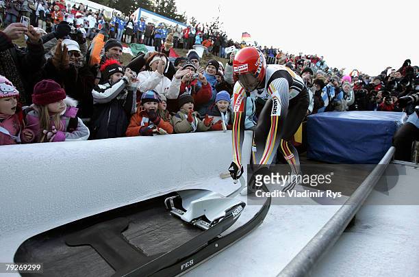 David Moeller of Germany pushes back his sledge after finishing second during the men's final race of the 40th Luge World Championships at the...