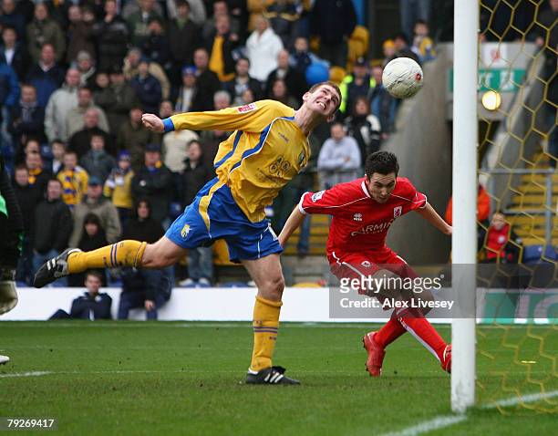 Jake Buxton of Mansfield Town heads the ball in to his own net under pressure from Stewart Downing of Middlesbrough to score an own goal during the...
