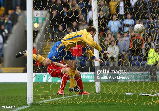 Jake Buxton of Mansfield Town heads the ball in to his own net under pressure from Stewart Downing of Middlesbrough to score an own goal during the...