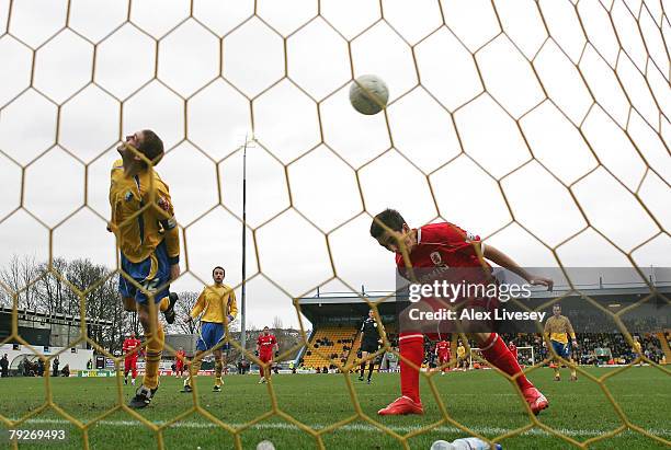 Jake Buxton of Mansfield Town heads the ball in to his own net under pressure from Stewart Downing of Middlesbrough to score an own goal during the...