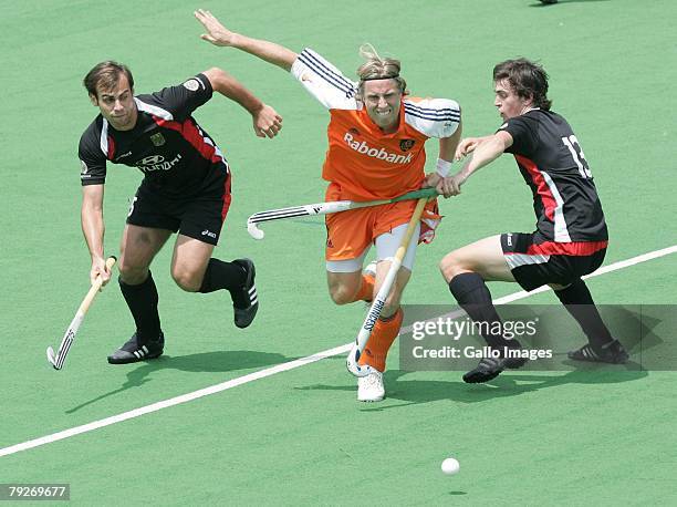 Roderick Wuesthof of Netherlands is challenged by Sebastian Biederlack and Tobias Hauke during the Five Nations Mens Hockey tournament match between...