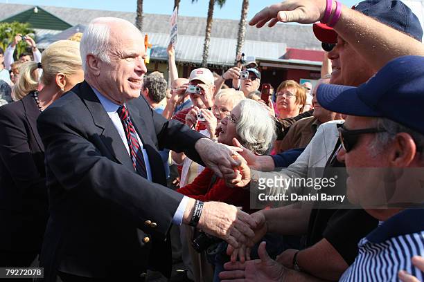 Republican presidential hopeful and Sen. John McCain shakes hands during a campaign stop at the Shell Factory January 26, 2008 in North Ft. Myers,...