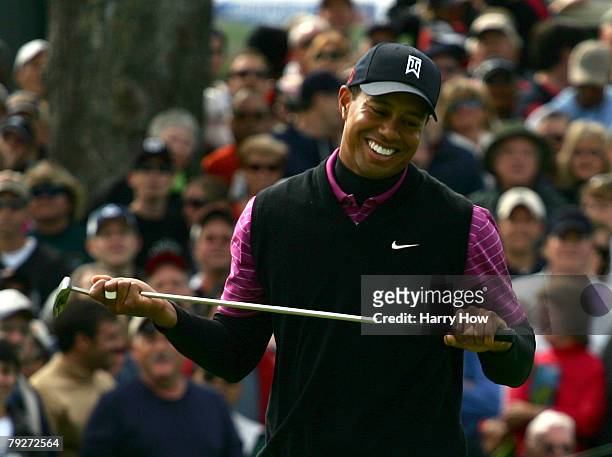 Tiger Woods smiles in reaction to his birdie attempt on the sixth hole during the third round of the Buick Invitational at the Torrey Pines Golf...