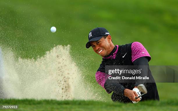 Tiger Woods hits out of the bunker on the 11th green during the third round of the Buick Invitational on January 26, 2008 at the Torrey Pines Golf...