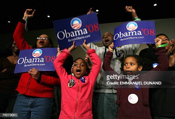 Supporters of US Democratic presidential candidate Illinois Senator Barack Obama celebrate as a television screen announces Obama as the winner in...