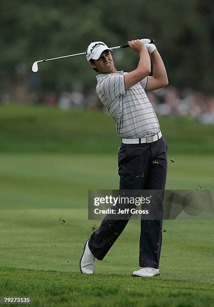 Aaron Baddeley of Australia watches his second shot on the 14th hole during the third round of the Buick Invitational at the Torrey Pines Golf Course...